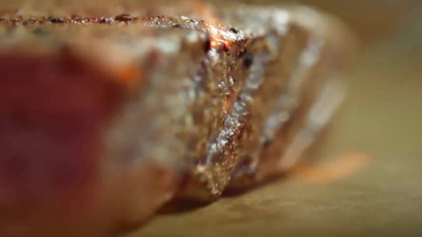 A tuna steak being torched with a flame