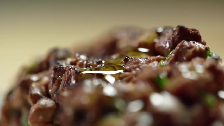 Oil being poured on top of tartare