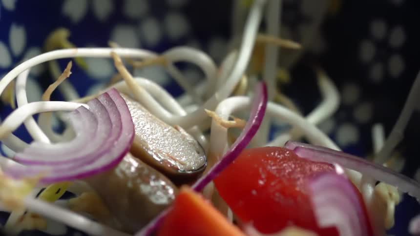 Onion falling into a bowl
