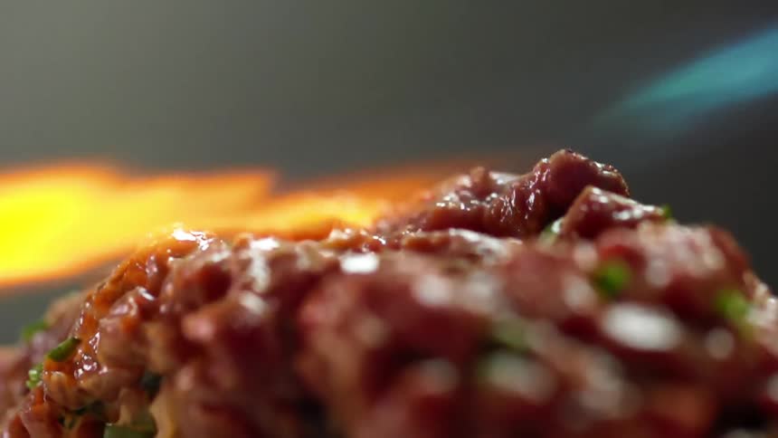 Chef uses the flames of a blowtorch to sear tuna tartare