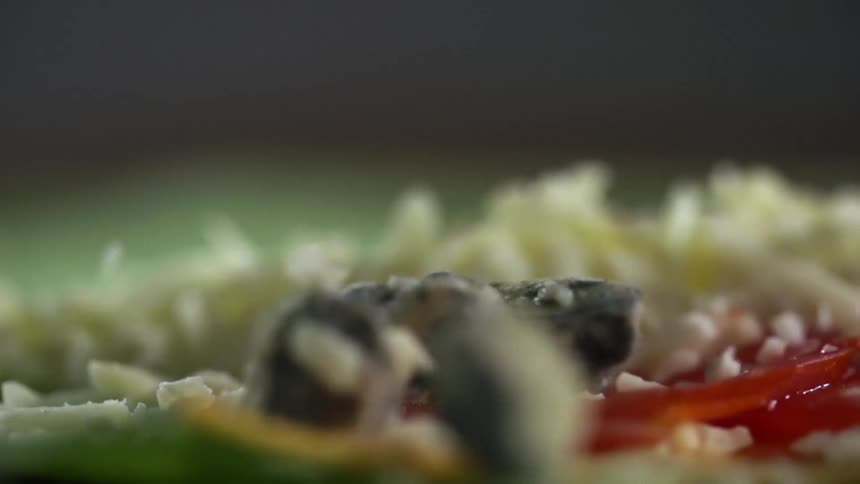 Chunks of bleu cheese are dropped onto vegetables as a topping