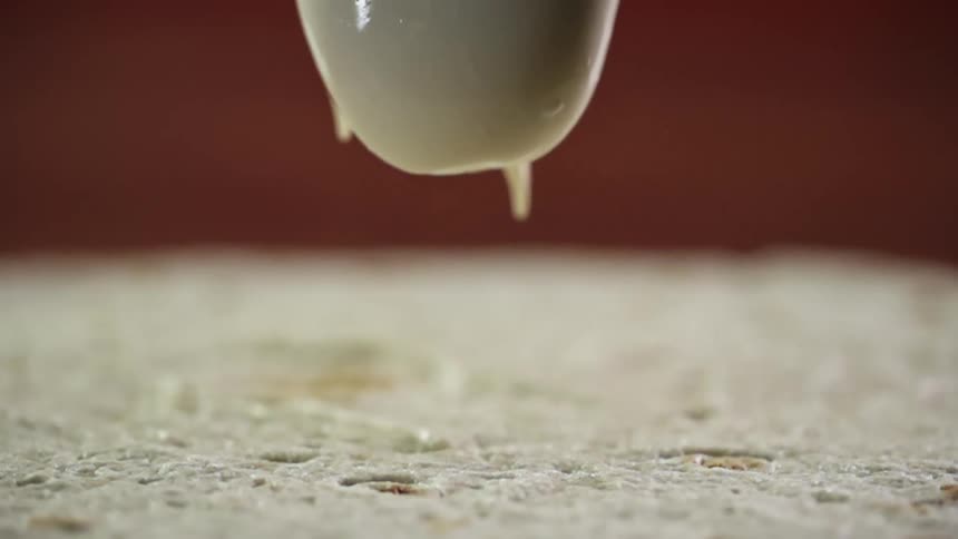 Cream being poured onto flatbread