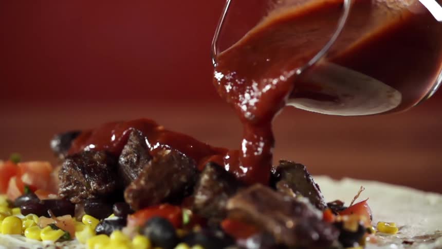 Sauce is poured on the food
