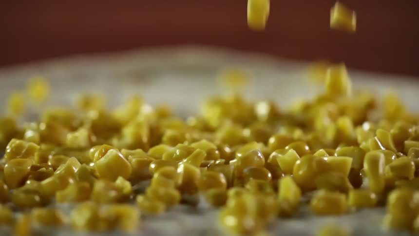 Yellow sweet corn falls over a bread tortilla