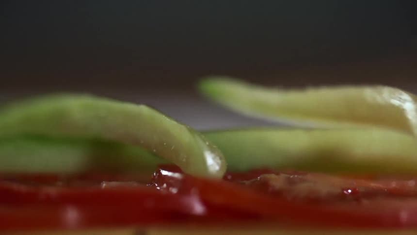 Pickles and tomatoes stacked for a photo shoot