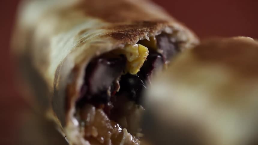 Bun is opened along slice to show interior stuffing