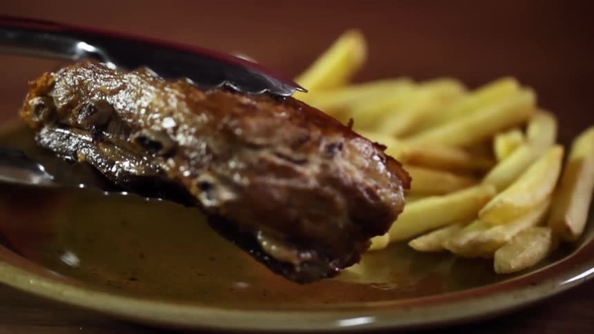 A steak is put on the plate with the fries