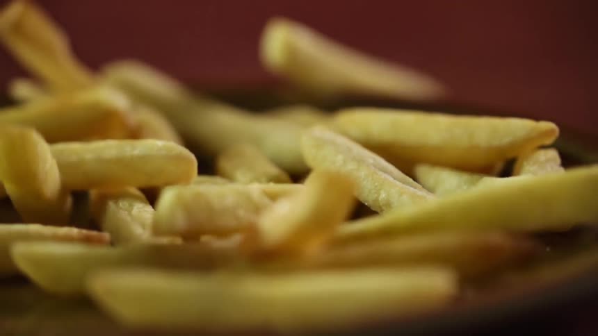 French fries falling on to a plate