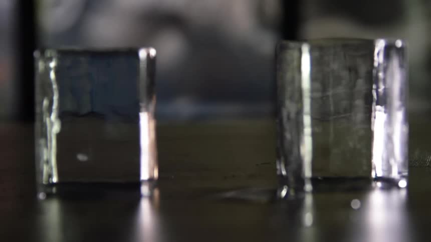 A rectangular ice cube spins atop a table