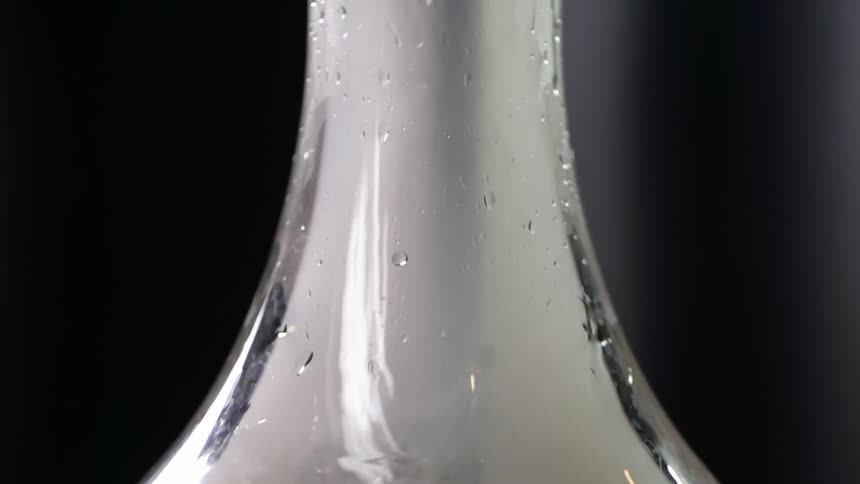Smoke rising inside a glass hookah's base