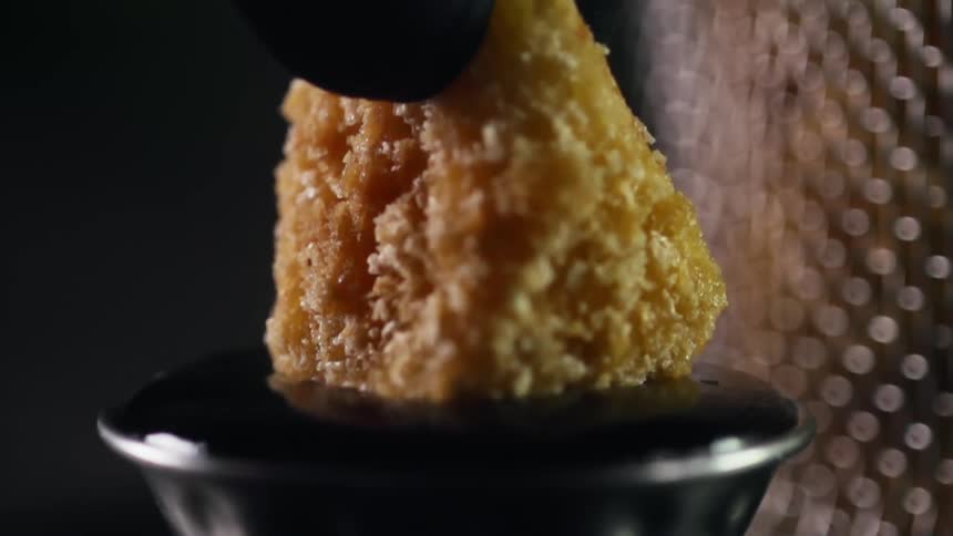 A fried chicken nugget is dipped into cranberry sauce