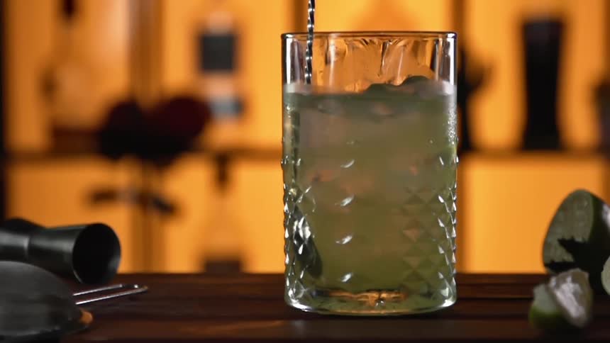 A drink being stirred on a bar top