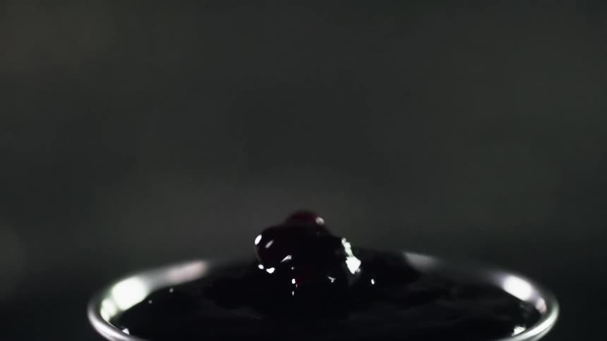 Cranberry sauce pours into the small bowl