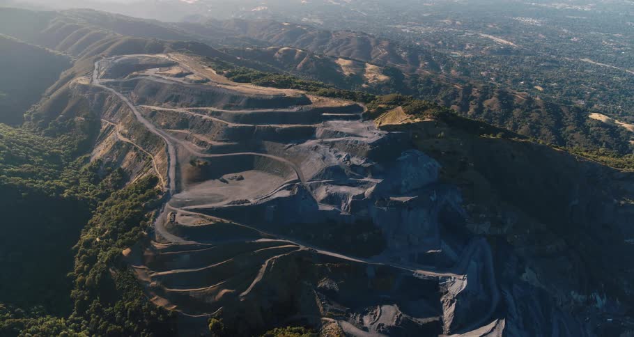Aerial view of a quarry mine in a slope on the side of a mountain