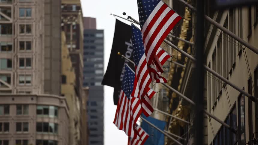American flags flowing in the wind from a government building