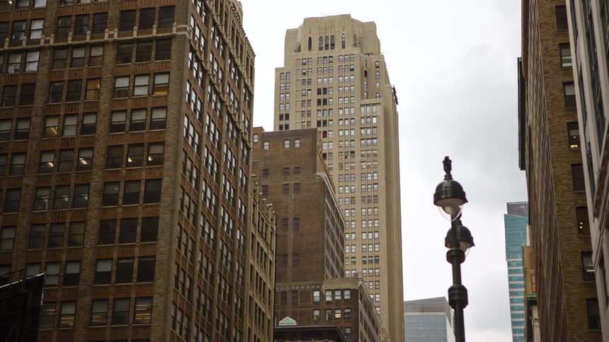 City street with tall buildings on a cloudy day
