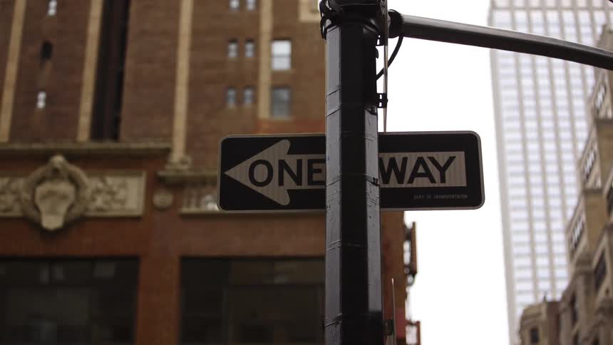 Close up of street one way sign in the middle of downtown