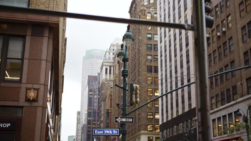 City street with tall buildings and shops in downtown on a cloudy day