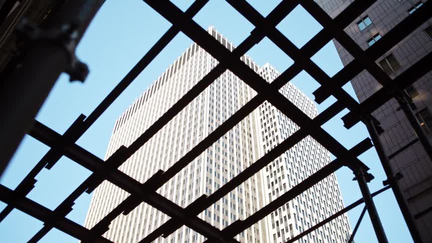 Metal scaffolding sits at the bottom of high rise buildings