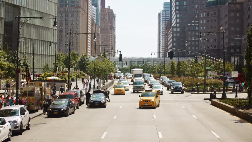 Bumper to bumper traffic heads down a one way four lane road in a city
