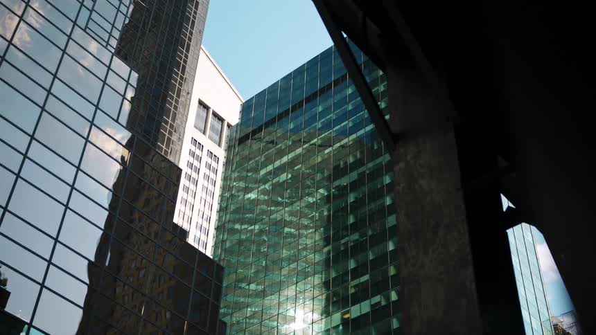 Several high rise buildings rise into the sky in a downtown area