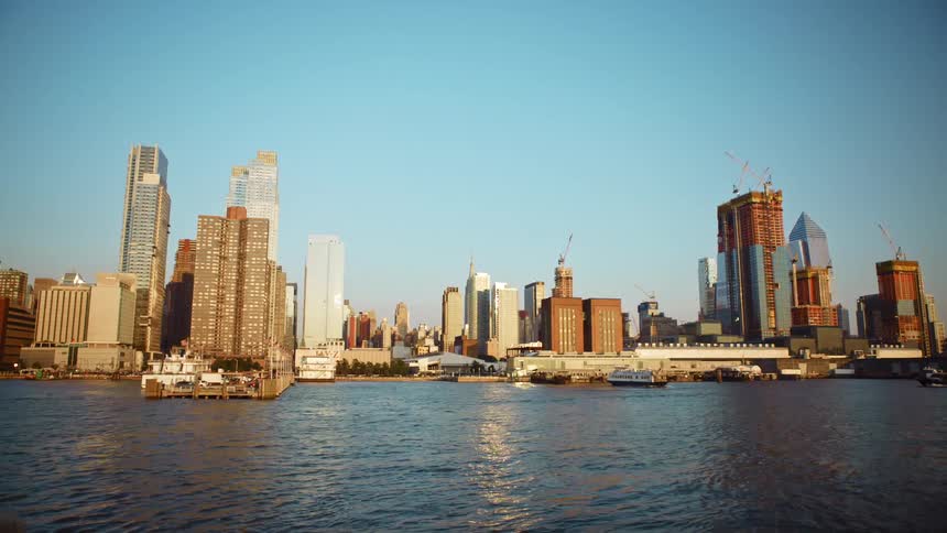 Boats on the water in front of a city skyline
