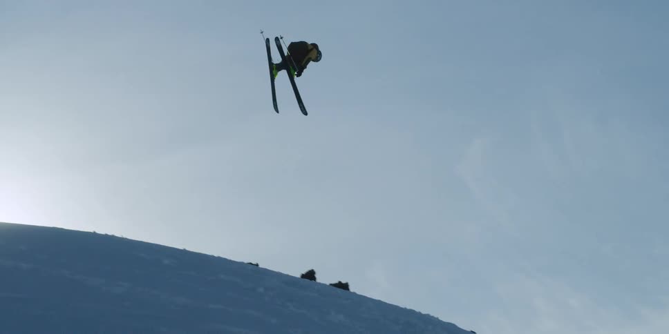 A skier jumps and spins before crashing