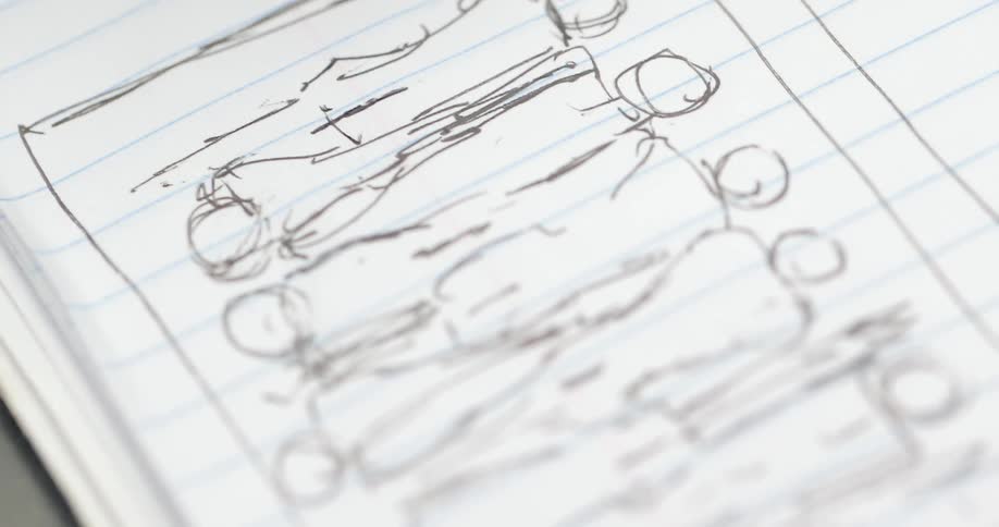 A pen is drawing in a notebook