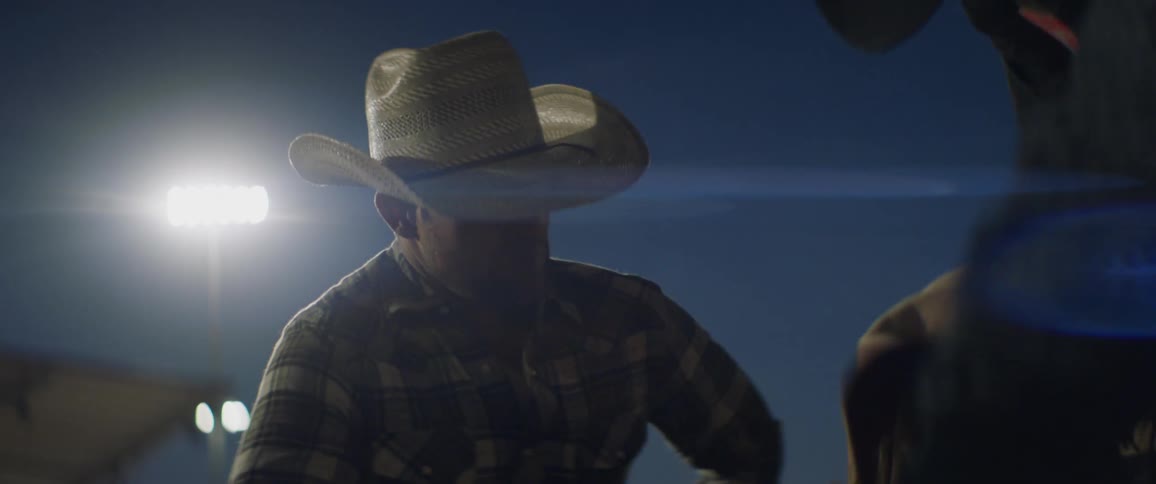 A rodeo cowboy prepares to ride