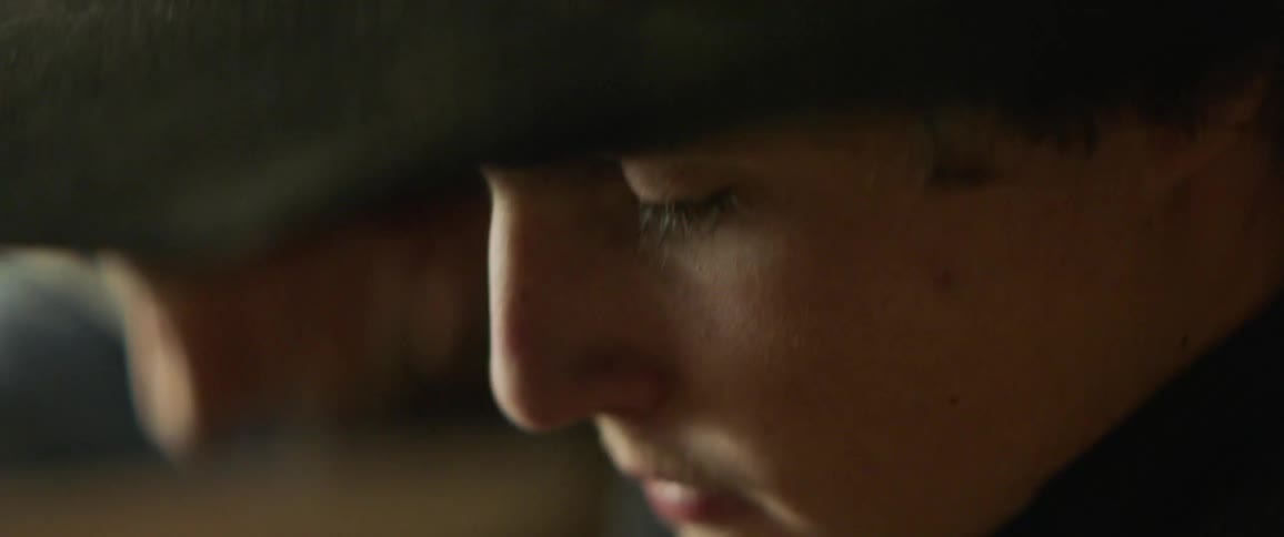 A man in a cowboy hat looks up while talking
