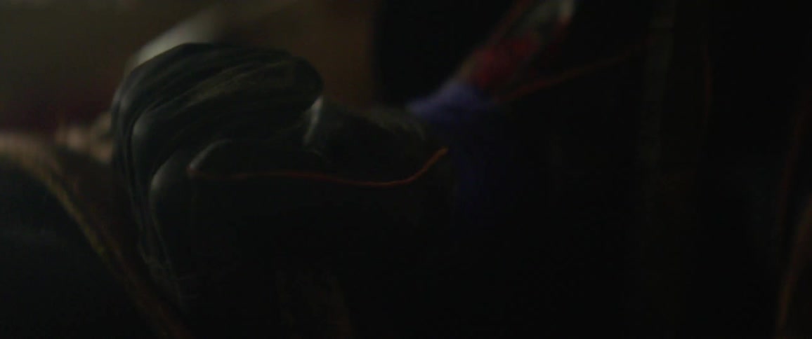 A man straps himself into a saddle