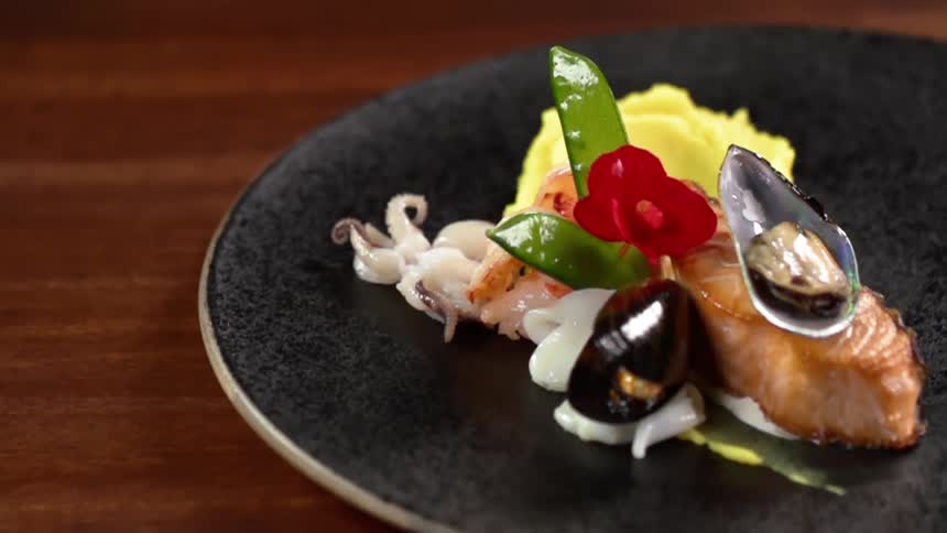 A flower is added on top of a meal as a garnish