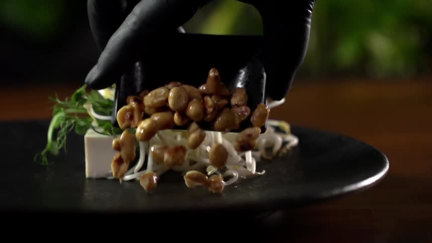 A person plating food at a restaurant