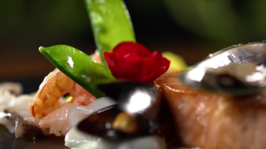 A dish of seafood turning around in a circle