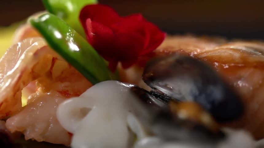 Gourmet dish of seafood with small vegetable decoration