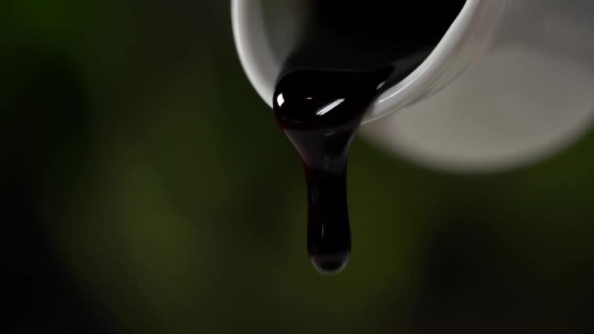 Sauce being poured out of a bowl