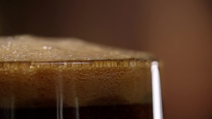 Bubbles and foam at the top of a glass of beer