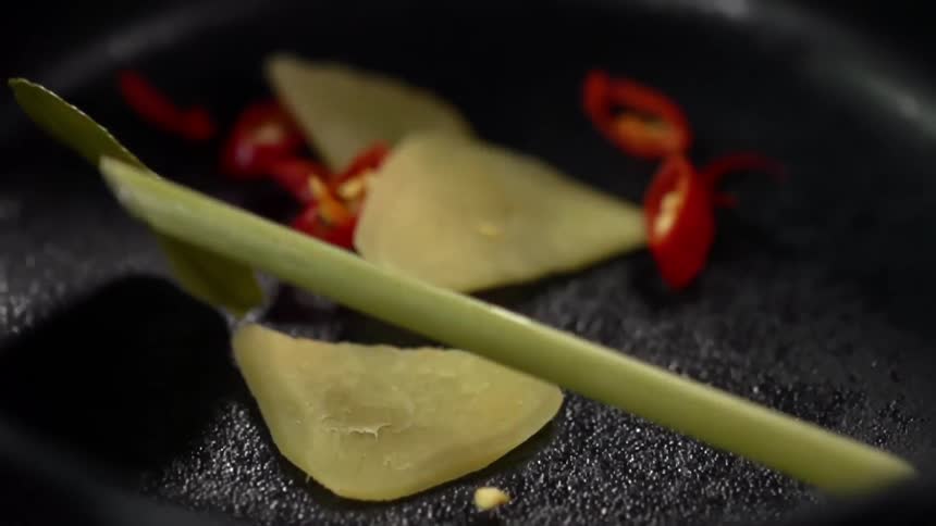 Close up of vegetables falling in pan to be cooked