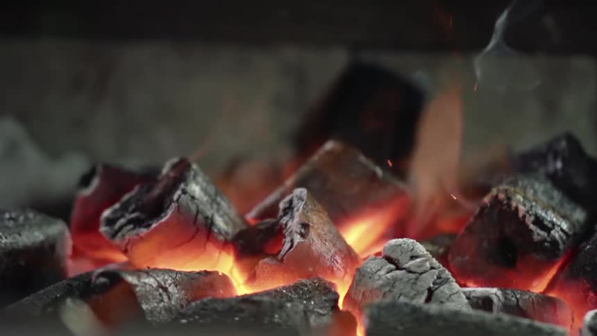 Wood chips smolder and burn in an oven