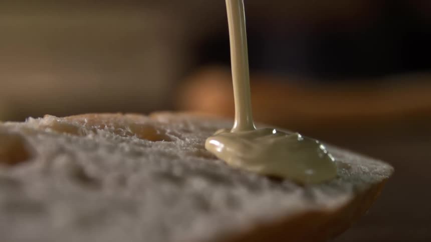 Sauce pours over a slice of bread