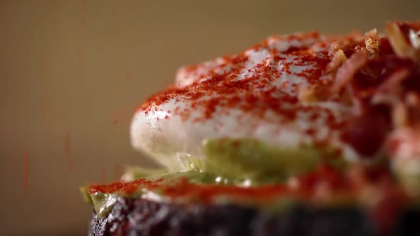Paprika falls onto a sandwich