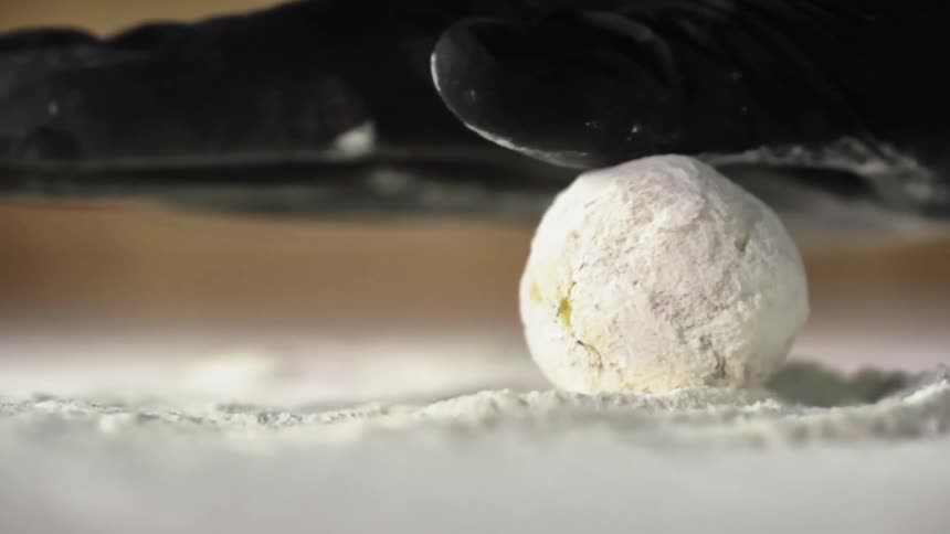 A ball is being rolled in flour