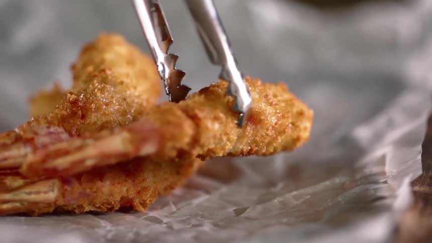 Fried shrimp being set on paper