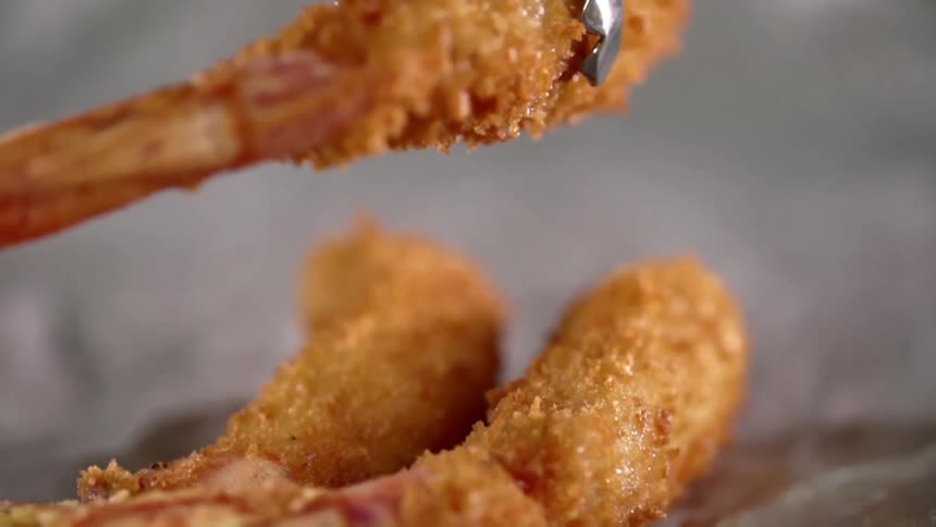 Fried shrimp being plated
