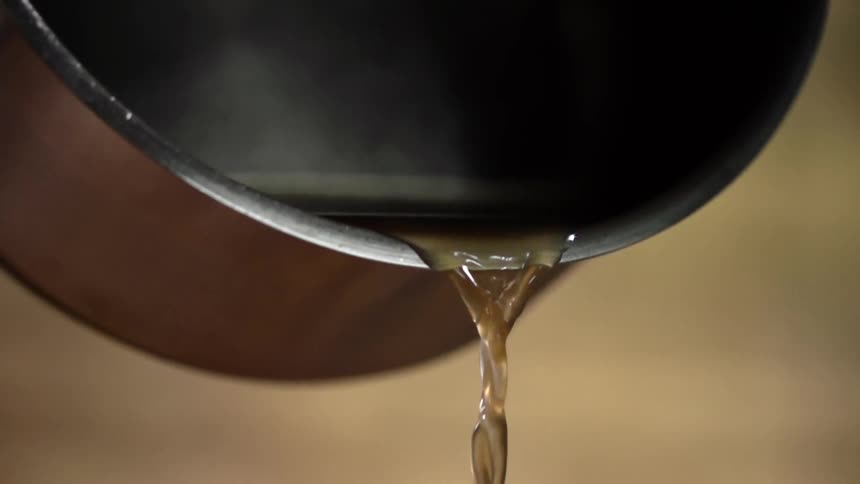 Liquid being poured out of a pan