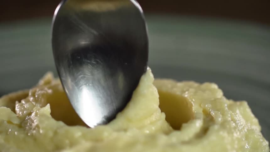 A spoon twisting in plated sauce