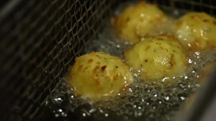 Biscuits are cooked in a deep fryer