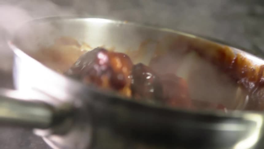 Wings are being tossed around in a pan