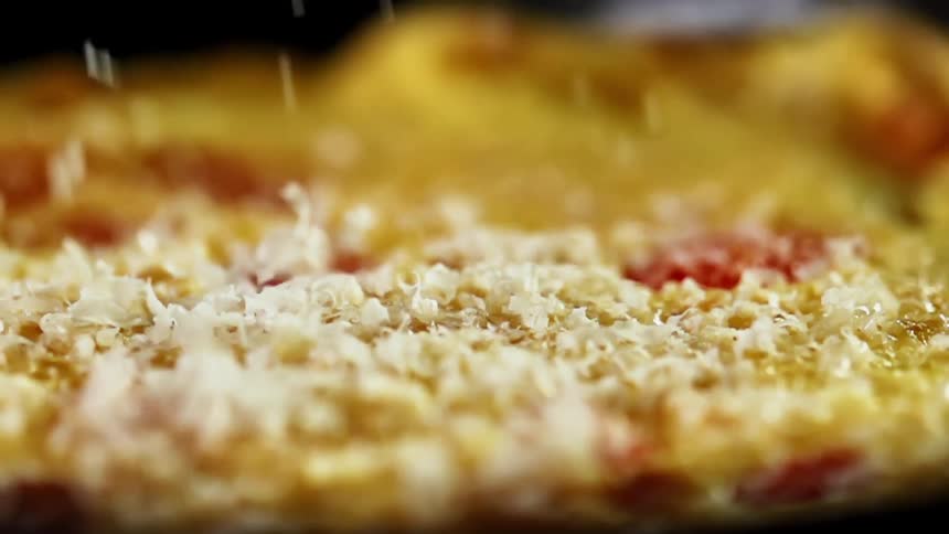 Shredded cheese sprinkling on a piece of food