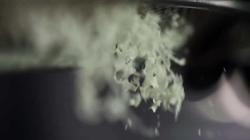 Cheese is being granted with a cheese grater